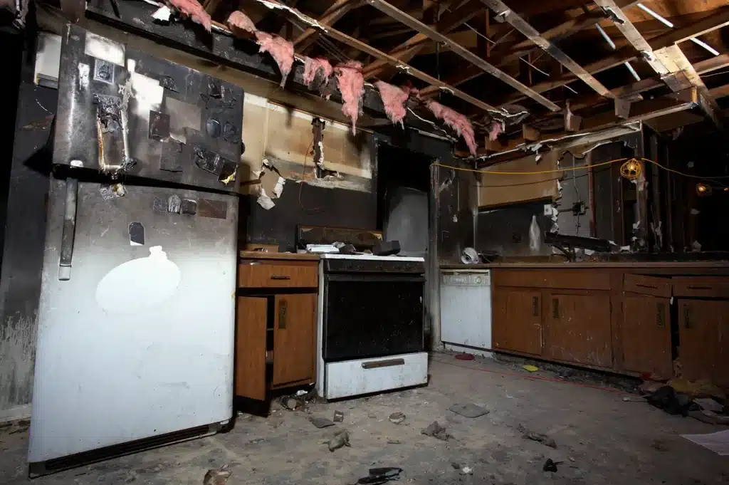 Interior of a kitchen severely damaged by fire.