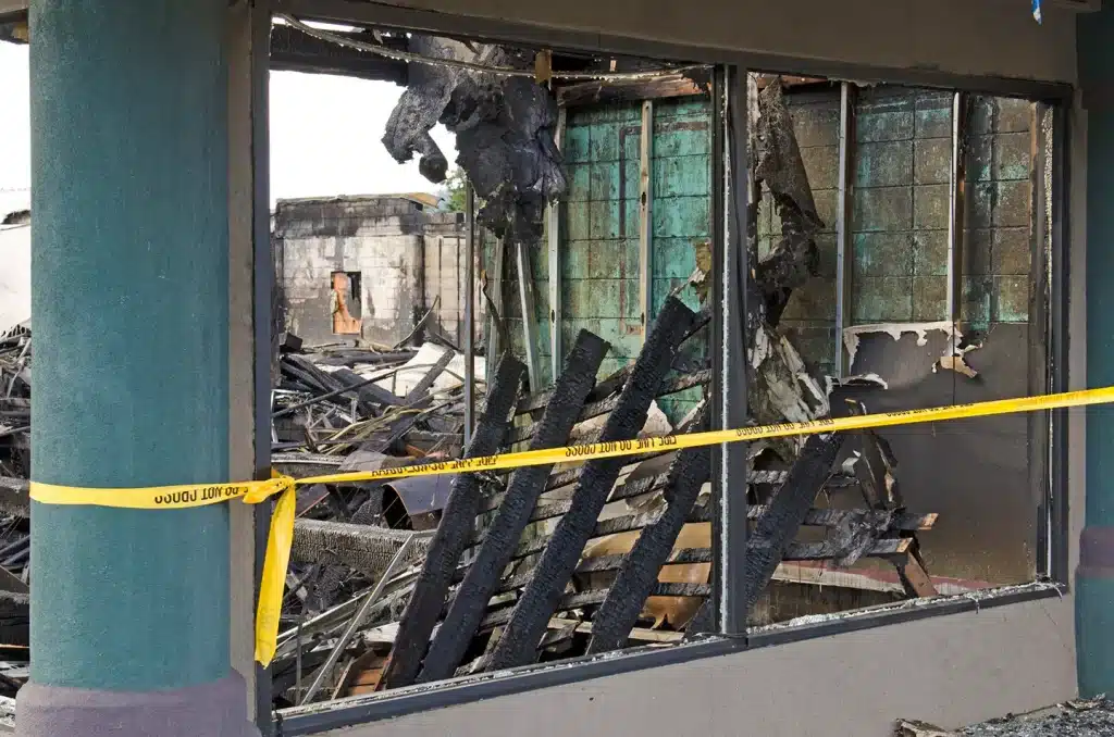 Charred remains of a fire‑damaged building interior.