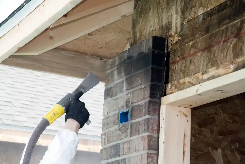 Smoke damage restoration work on exterior wall by a Phoenix Restoration professional.