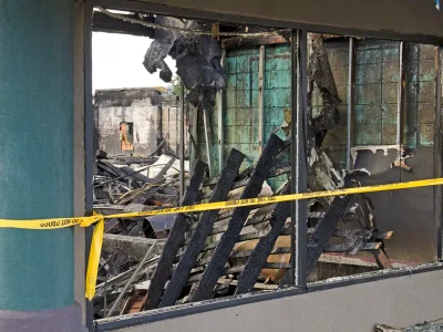 Charred remains of a fire‑damaged building interior.